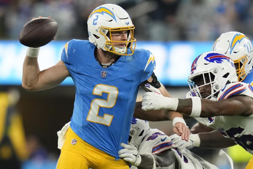 Los Angeles Chargers quarterback Easton Stick (2) is pressured by Buffalo Bills.