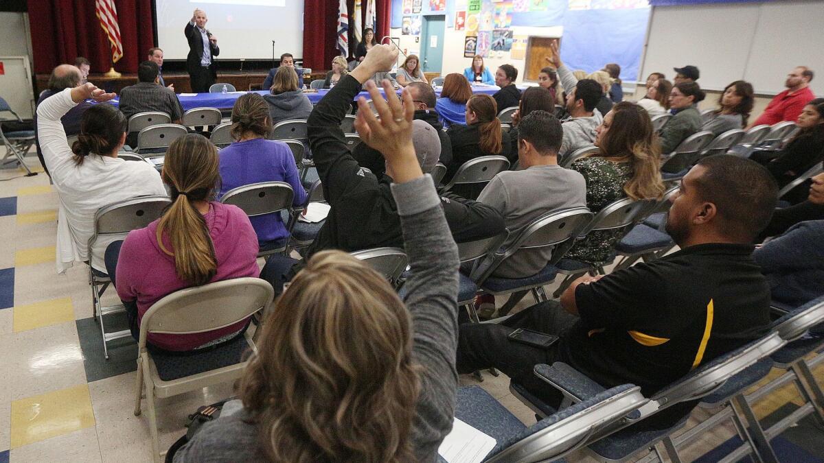 Burbank Unified Supt. Matt Hill points to a woman raising her hand during a town hall meeting at Disney Elementary last week. During the meeting, a modified modernization plan that included a two-story modular structure was presented.