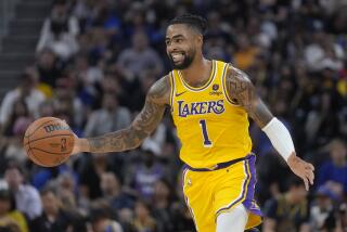 Los Angeles Lakers guard D'Angelo Russell brings the ball upcourt against the Golden State Warriors during the first half of an NBA preseason basketball game in San Francisco, Saturday, Oct. 7, 2023. (AP Photo/Jeff Chiu)