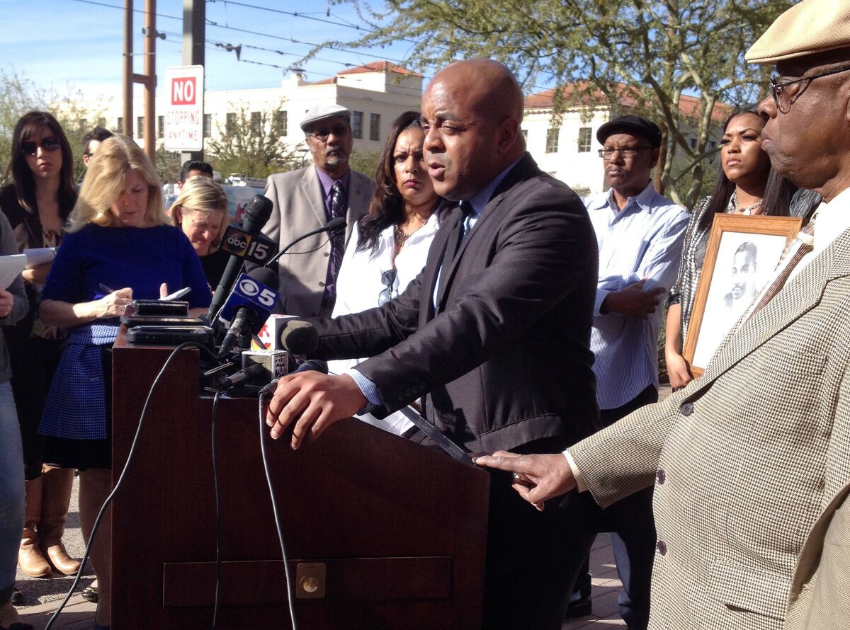 The Rev. Jarrett Maupin, center, an Arizona civil rights activist, at a news conference in Phoenix on Tuesday.