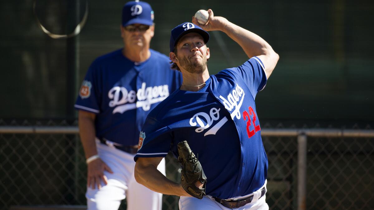 Dodgers ace Clayton Kershaw warms up under the watch of pitching coach Rick Honeycutt before throwing batting practice during spring training in February 2016.