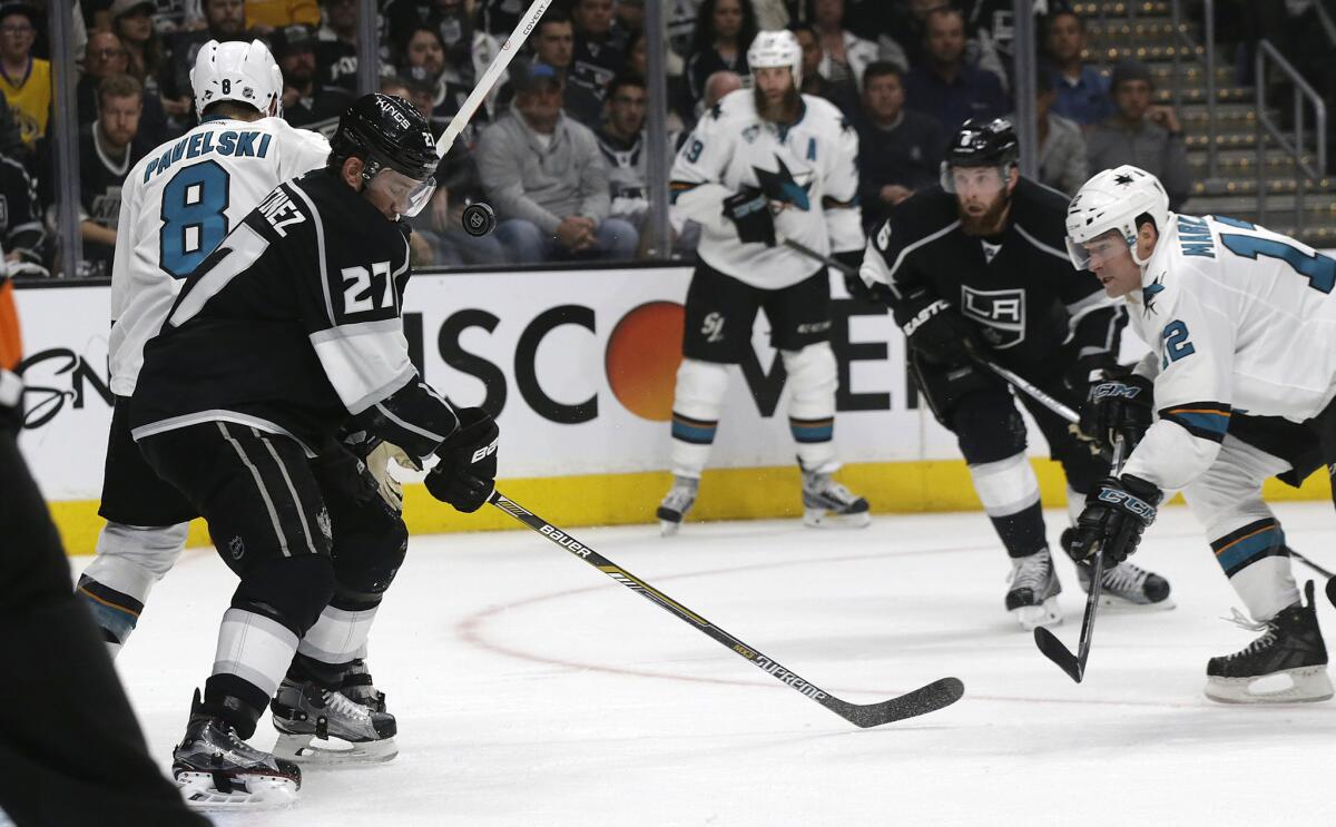 Kings defenseman Alec Martinez gets an eye-level view of the puck against the Sharks in the second period.