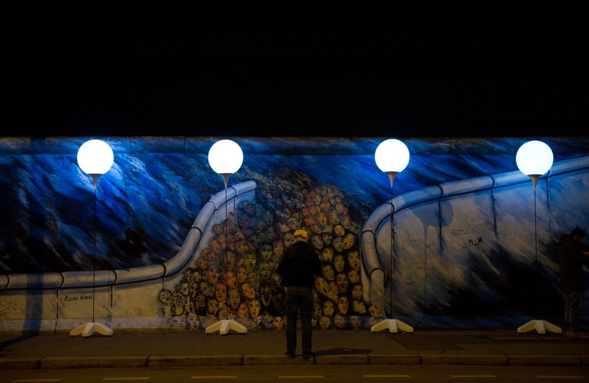 Lighted balloons trace the former path of the Berlin Wall, a public art installation to mark the 25th anniversary of the demise of the Cold War barrier. On Sunday's anniversary, the 8,000 balloons will be released.