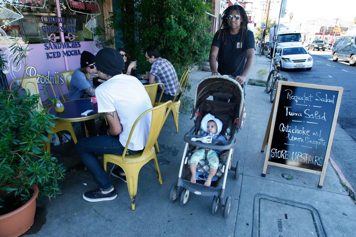 John Montgomery takes his daughter Mirabelle for a stroll along Sunset Boulevard in Silver Lake.