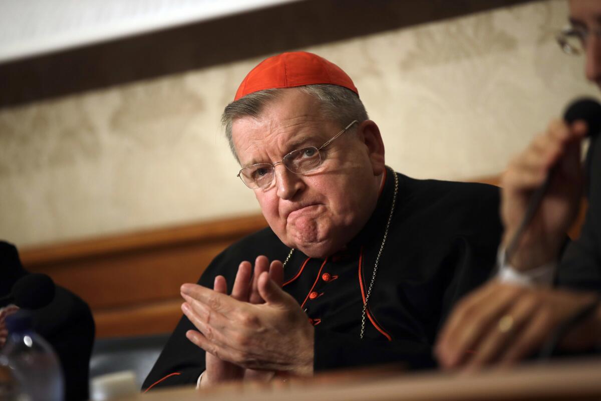 FILE - In this Sept. 6, 2018 file photo, Cardinal Raymond Burke applauds during a press conference at the Italian Senate, in Rome. Cardinal Burke, one of the Catholic Church's most outspoken conservatives and a vaccine skeptic, said he has COVID-19 and his staff said he is breathing through a ventilator. Burke tweeted Aug. 10 that he had caught the virus, was resting comfortably and was receiving excellent medical care. (AP Photo/Alessandra Tarantino, File)