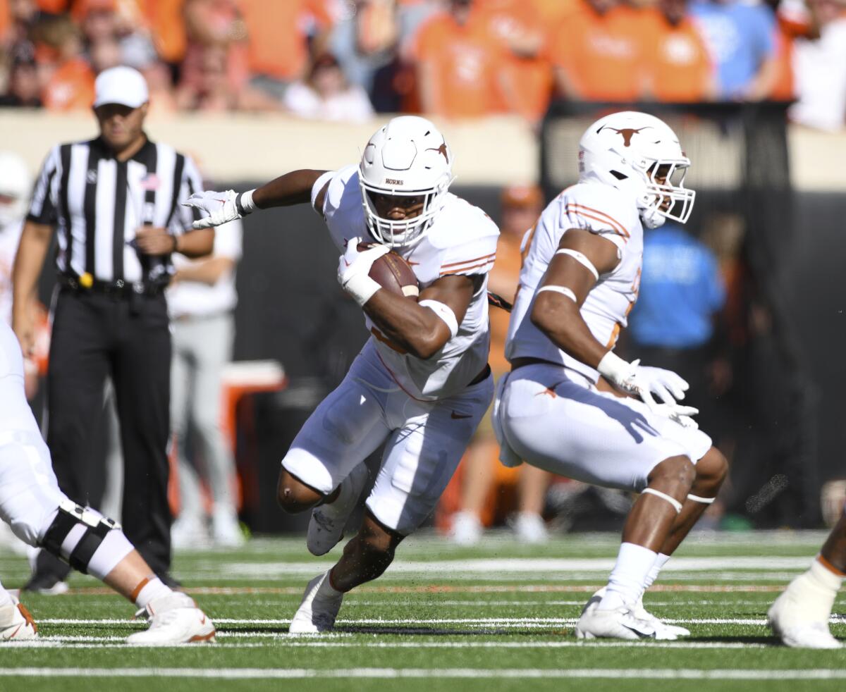 Texas running back Bijan Robinson carries the ball during a loss to Oklahoma State on Oct. 22.