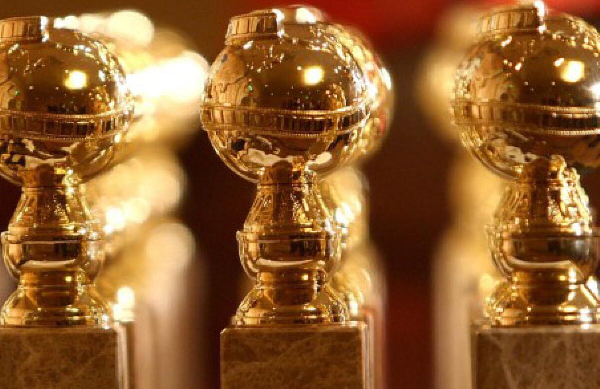 A lineup of Golden Globe statuettes