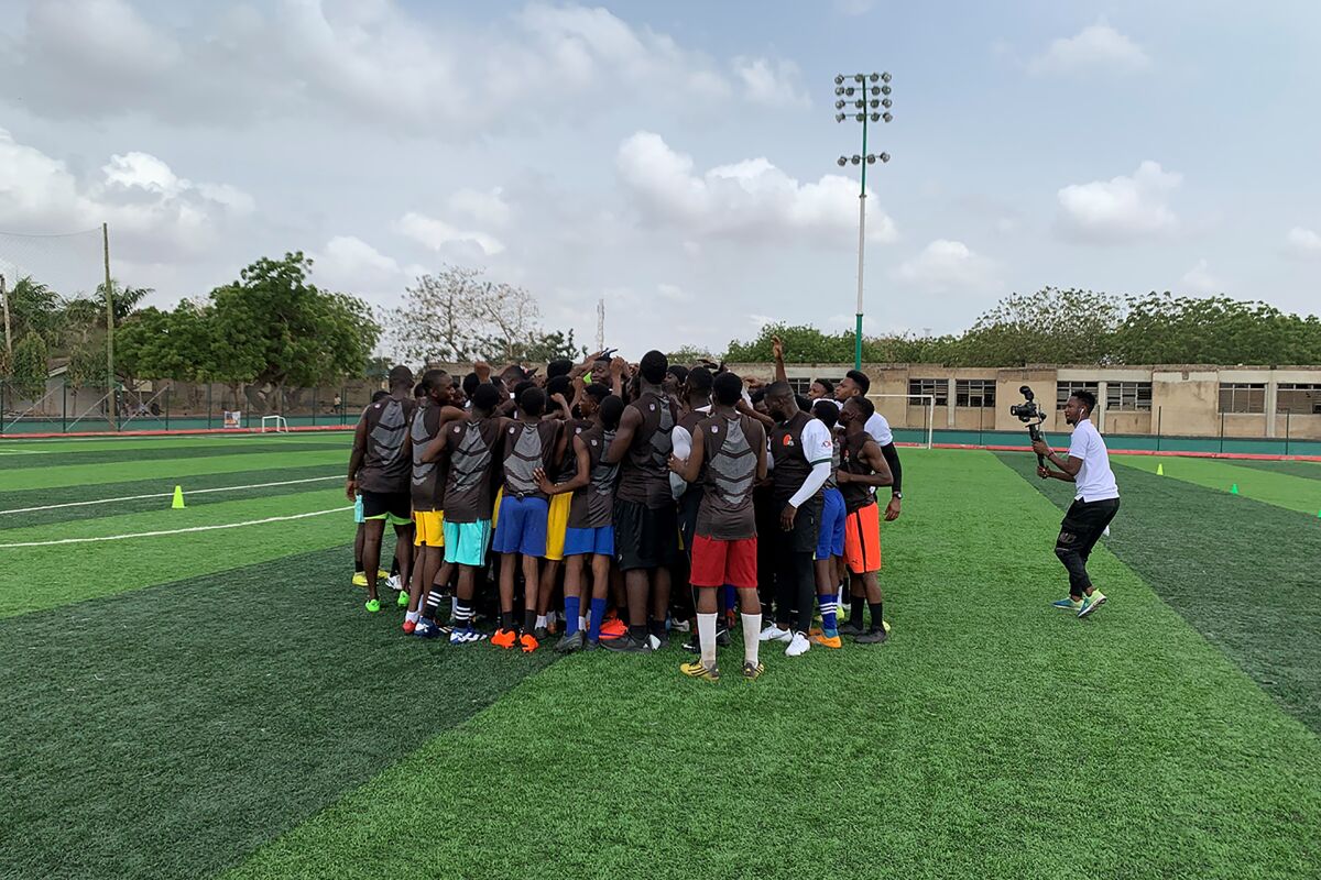 This image provided by the NFL shows Cleveland Browns linebacker Jeremiah Owusu-Koramoah, at center of group facing the camera, during a football camp at Adjinganor Field in Accra, Ghana, April 2, 2022. Following the camp this past weekend, the NFL announced a three-day camp will take place in the capital of Accra in June. (Emily Wirz/NFL via AP)