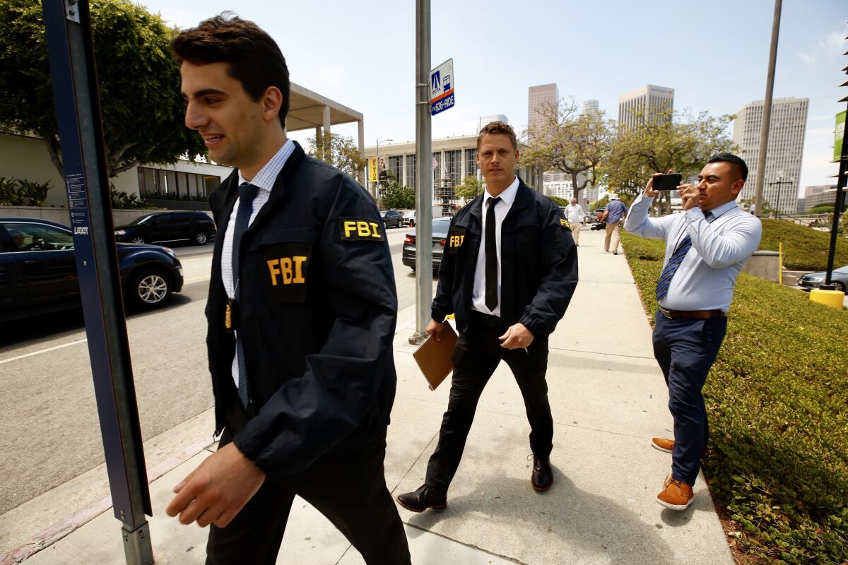 FBI agents leave the downtown headquarters of the Los Angeles Department of Water and Power after serving a search warrant Monday, July 22, 2019.