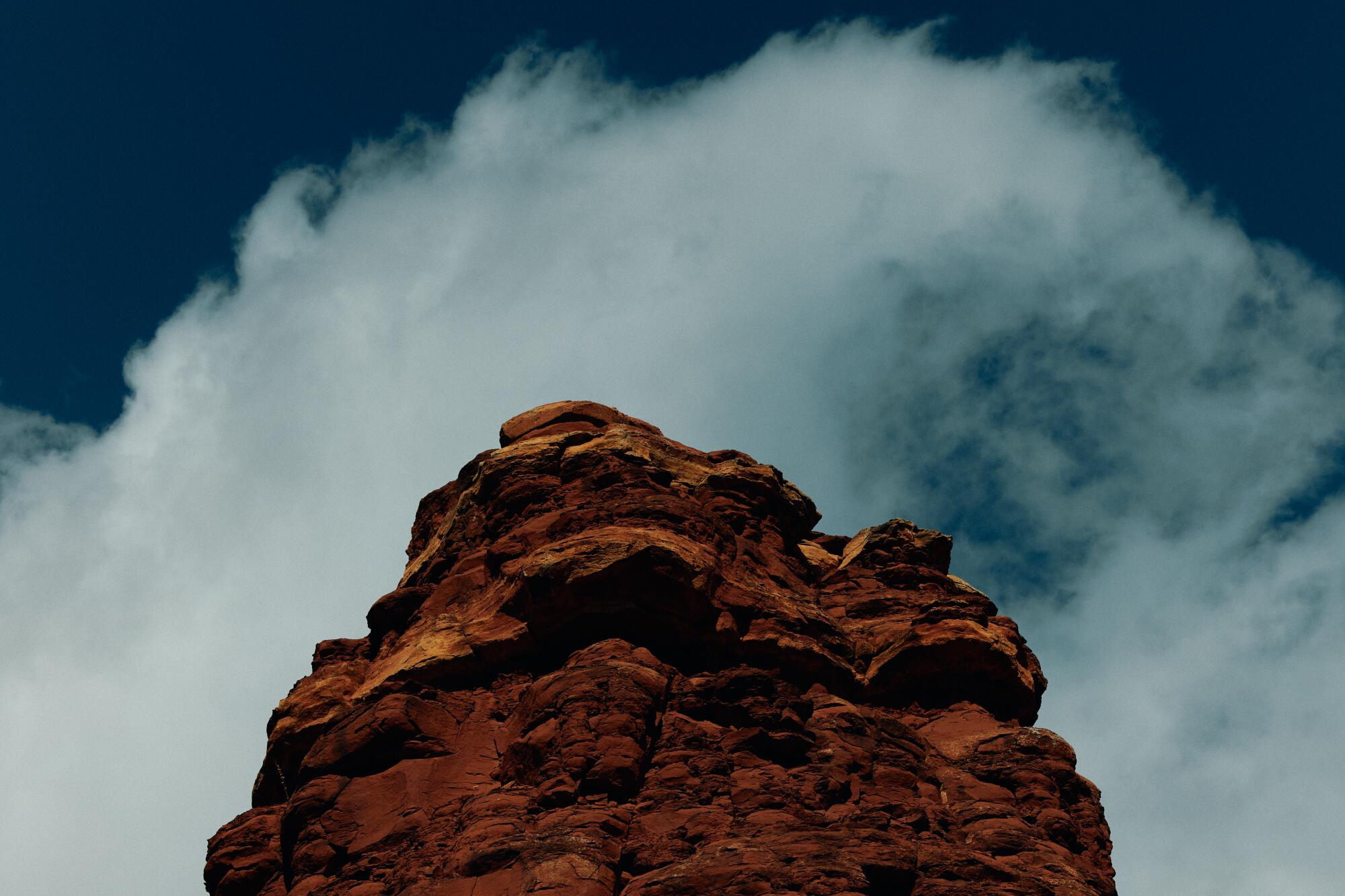 A rock formation at the Boynton Pass Vortex in front of a cloudy sky.