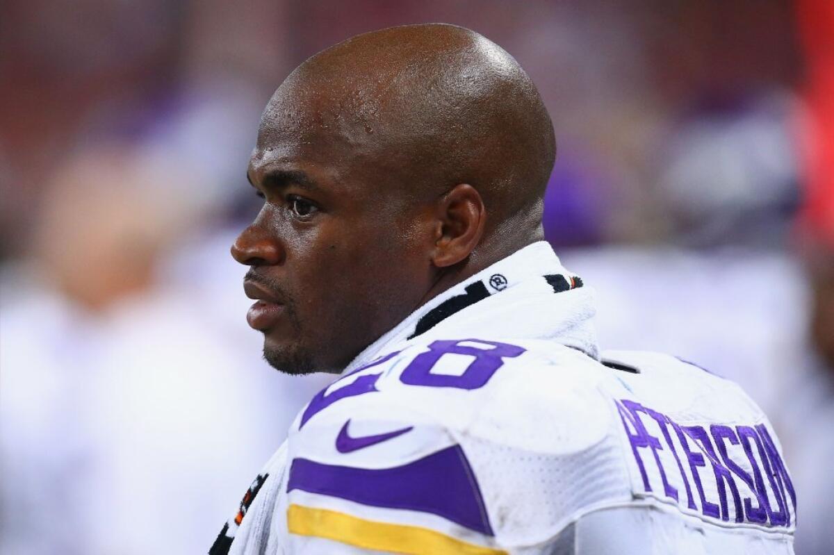 Adrian Peterson looks on from the sideline during a game against the St. Louis Rams on Sept. 7.