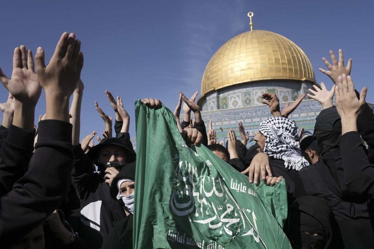 Palestinians holding a Hamas flag protest by the Dome of the Rock Mosque in the Old City of Jerusalem on Jan. 27.