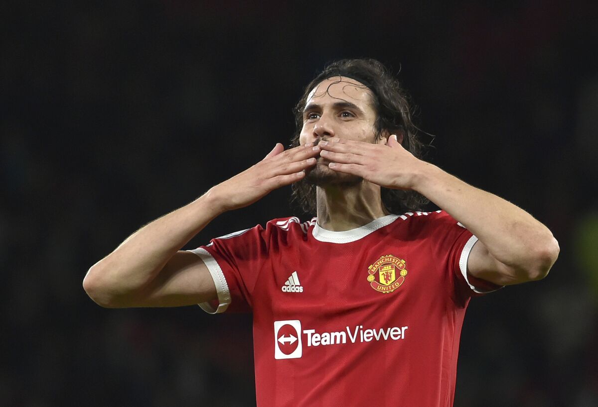 Manchester United's Edinson Cavani cheers supporters at the end of the English Premier League soccer match between Manchester United and Burnley at Old Trafford in Manchester, England, Thursday, Dec. 30, 2021. (AP Photo/Rui Vieira)