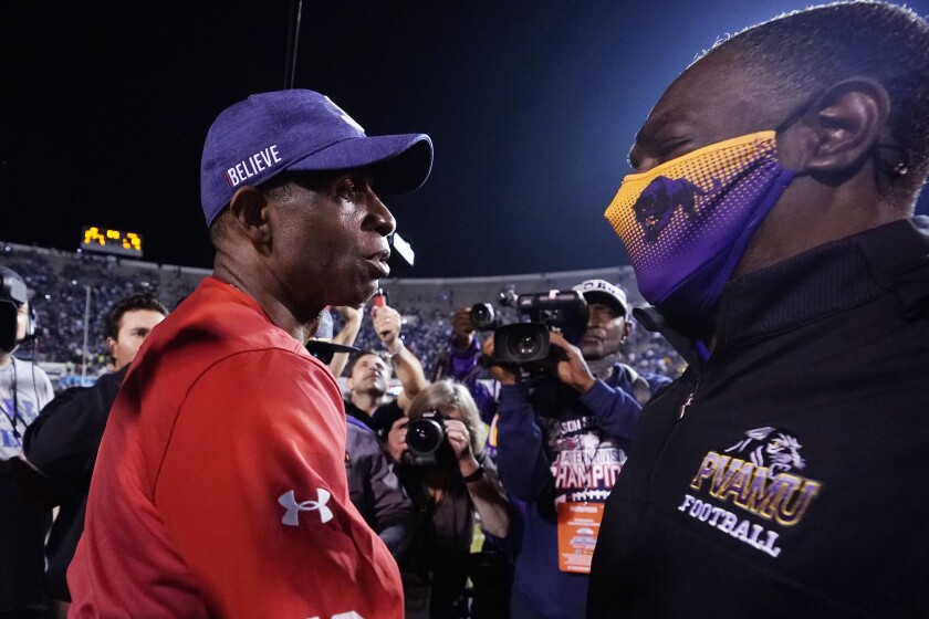 Jackson State head coach Deion Sanders left, is congratulated by Prairie View head coach Eric Dooley at the conclusion of the Southwestern Athletic Conference championship NCAA college football game, Saturday, Dec. 4, 2021, in Jackson, Miss. Jackson State won 27-10. (AP Photo/Rogelio V. Solis)