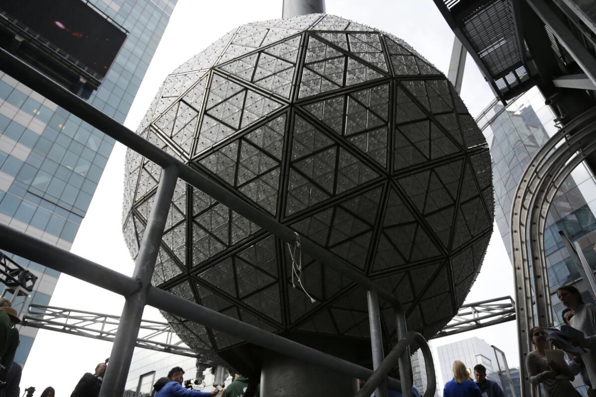 The New Year's Eve ball rests at the top of a building overlooking Times Square in New York on Tuesday.