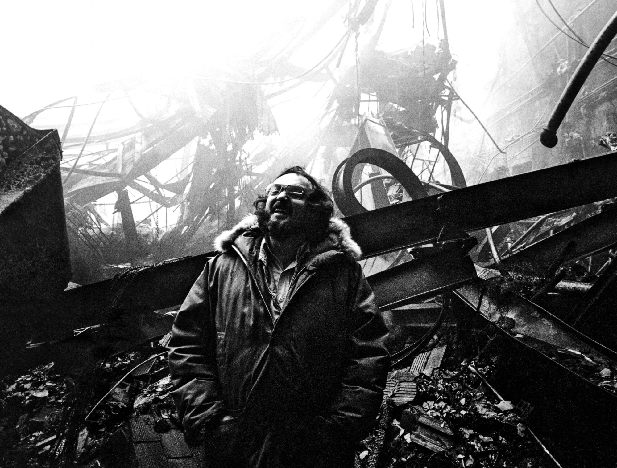 Kubrick stands in front of the wreckage of Stage 3, with the huge set of the Colorado Lounge set on fire.