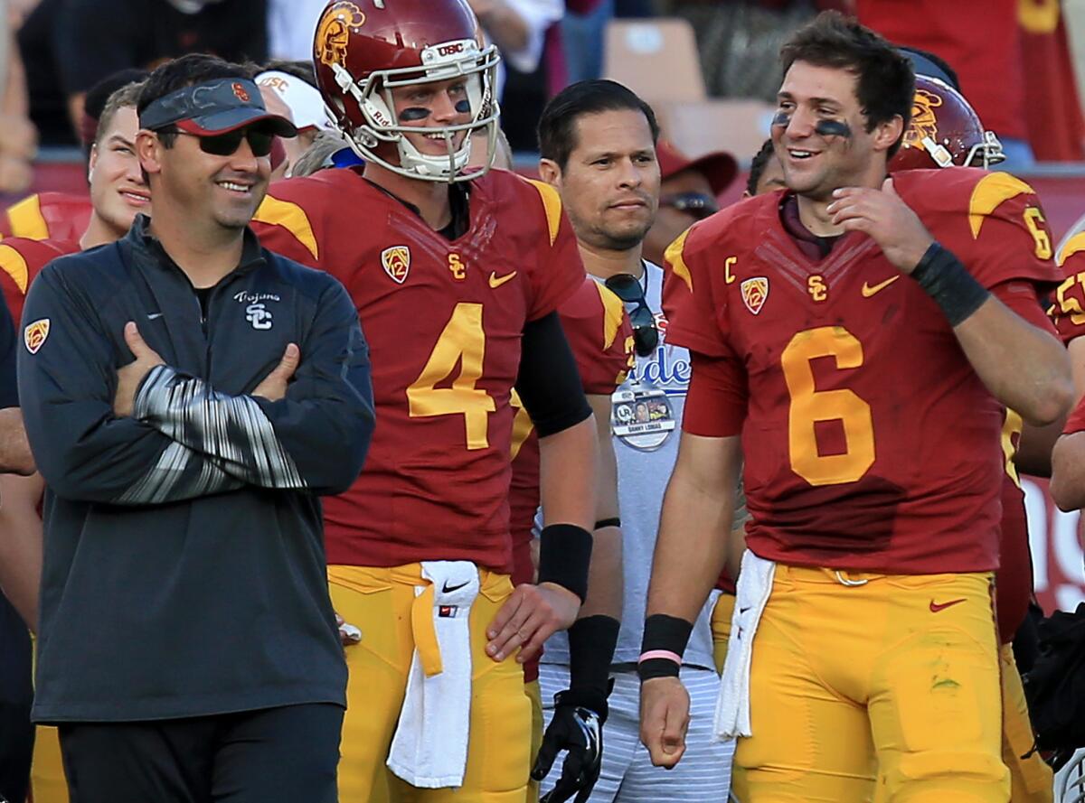USC Coach Steve Sarkisian and quarterback Cody Kessler share a light moment during the Trojans' victory over Notre Dame on Nov. 29.