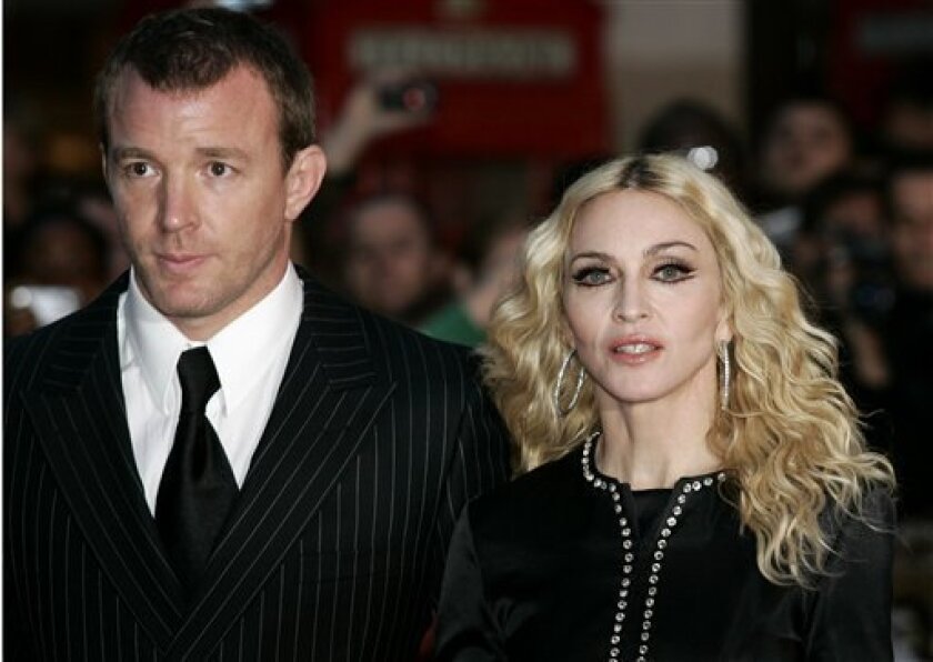 In this Sept. 1, 2008 file photo, British director Guy Ritchie, left, and his wife Madonna arrive for the world premiere of his film "Rock n Rolla" in London. ." (AP Photo/Sang Tan, file)