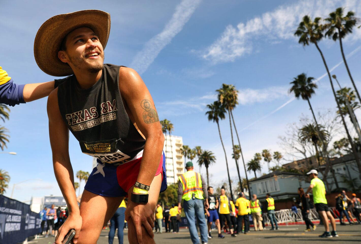 Race participant Jose Lara of Houston, Texas, catches his breath after finishing the L.A. Marathon on Sunday.