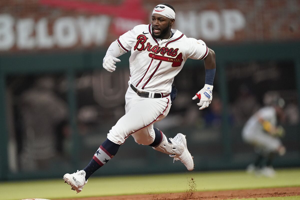 Atlanta Braves' Michael Harris II runs to third base on a two-run triple during the fifth inning of the team's baseball game against the Oakland Athletics on Wednesday, June 8, 2022, in Atlanta. (AP Photo/John Bazemore)
