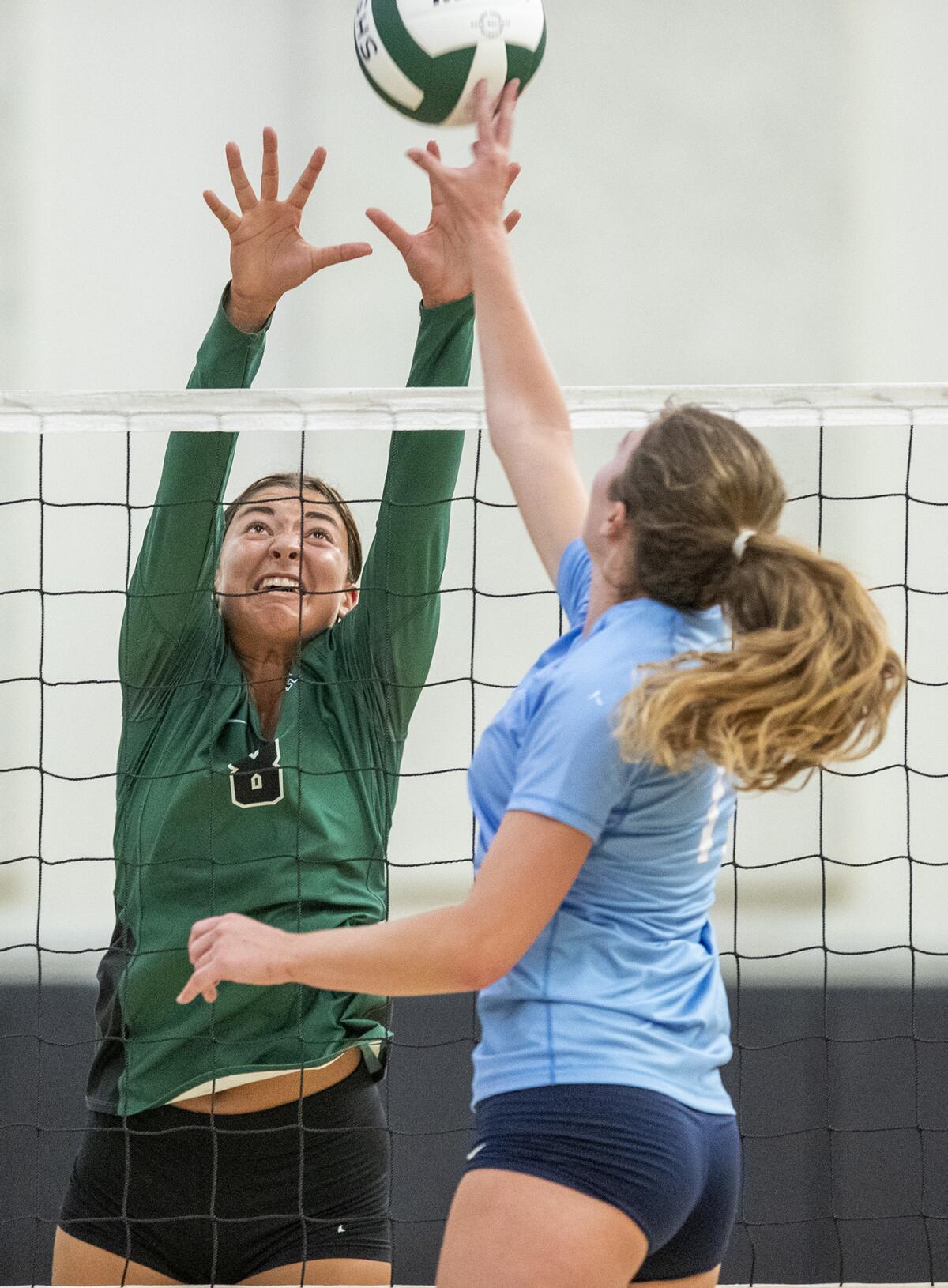 Sage Hill's Brooke Thomassen, attempts to block a ball from Corona del Mar's Reese Olson during a season opener on Aug. 16.