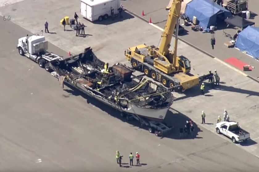 The burned hull of the Conception sits sits on top of a big rig trailer at the Seabee base in Port Hueneme after being raised from the ocean bottom off Santa Cruz Island. (Mandatory credit KABC-TV)