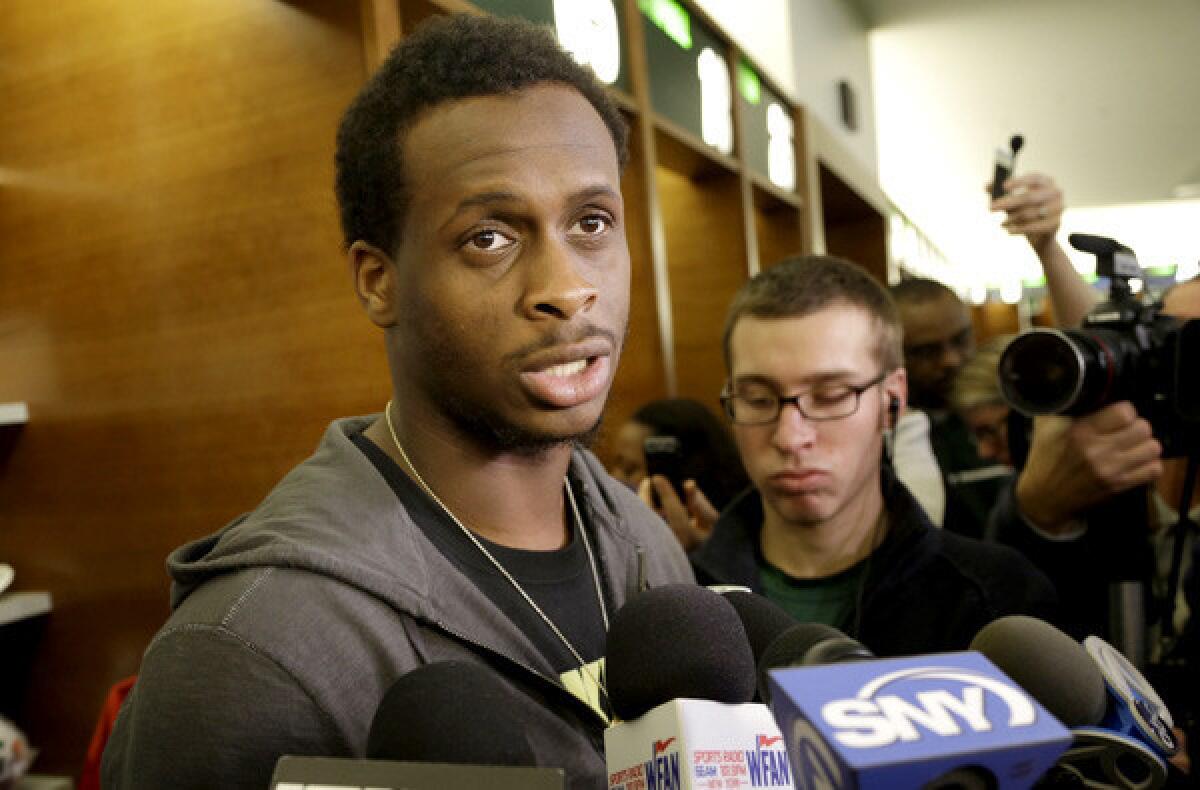 New York Jets quarterback Geno Smith speaks to reporters in the locker room of the Jets training facility after the end of the season.