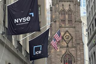 Flags fly on the side of the New York Stock Exchange with Trinity Church in the background on Wednesday, Aug. 28, 2024, in New York. (AP Photo/Peter Morgan)