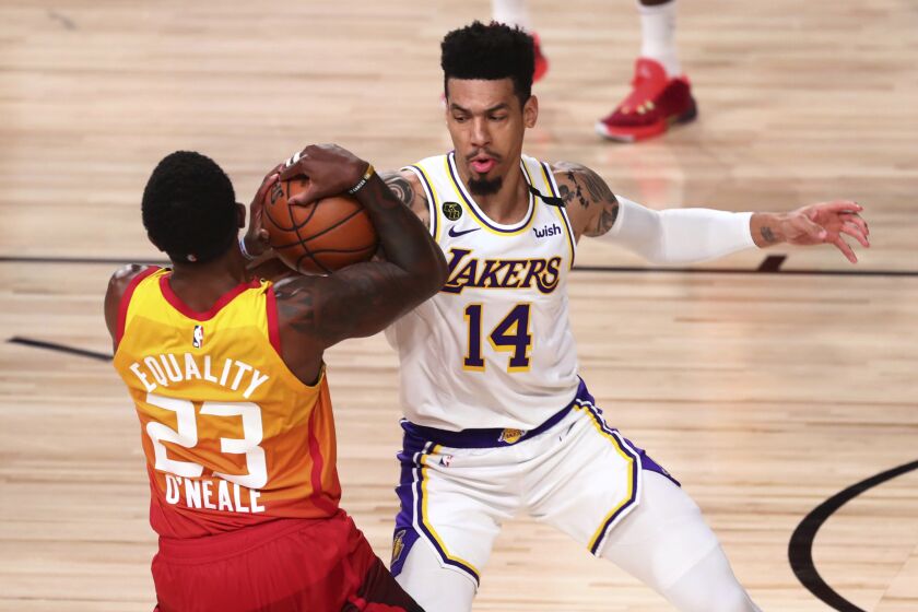 Utah Jazz forward Royce O'Neale (23) holds the ball away from Los Angeles Lakers guard Danny Green (14) during the second half of an NBA basketball game Monday, Aug. 3, 2020, in Lake Buena Vista, Fla. (Kim Klement/Pool Photo via AP)