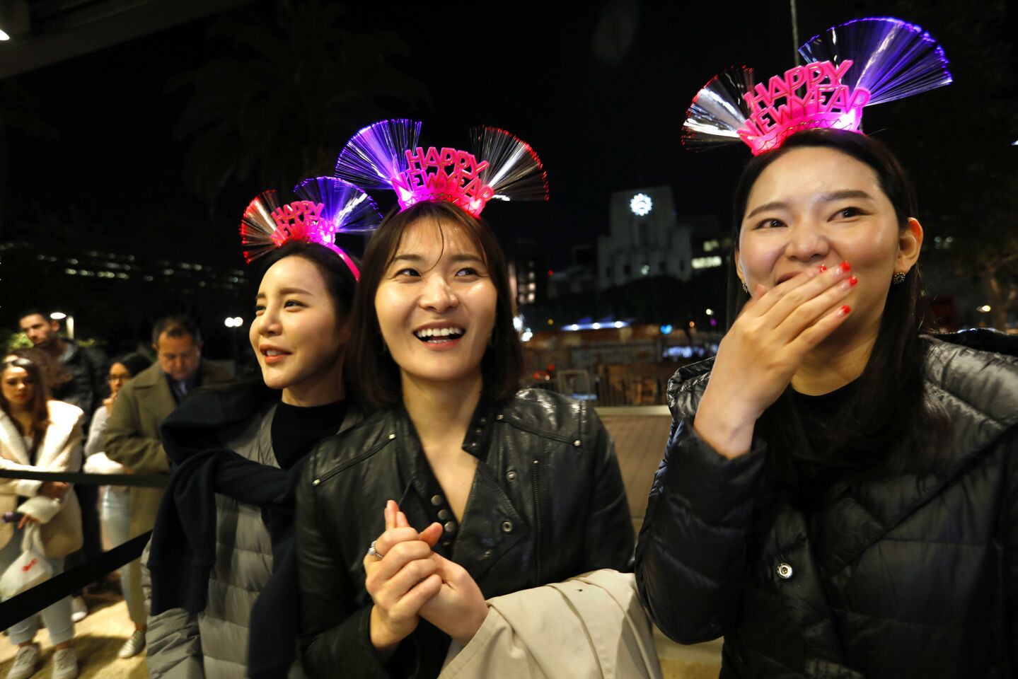 Sunny Jang, left, Hayden Bark and Jinney Lee were among those on hand for the New Year's Eve celebration at Grand Park and the Music Center in downtown Los Angeles. About 50,000 people were expected to attend. The theme was L.A. Dreams, which, according to the Music Center, "imagines the future of L.A. County" through the "thoughtfulness and creativity of its children." Local fifth-graders contributed essays, drawings and more.