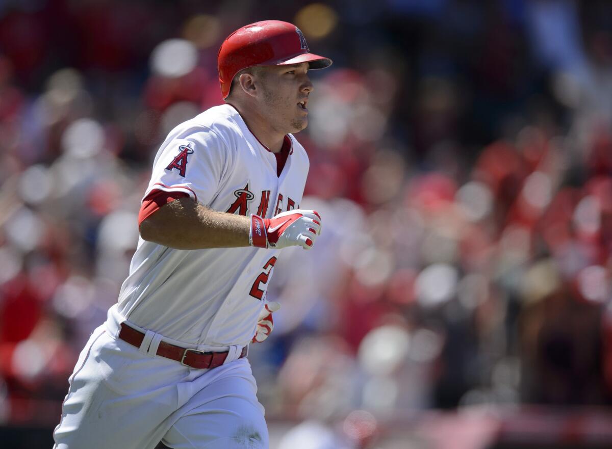 Angels outfielder Mike Trout jogs around the bases after hitting a grand slam against the Rangers on July 26.