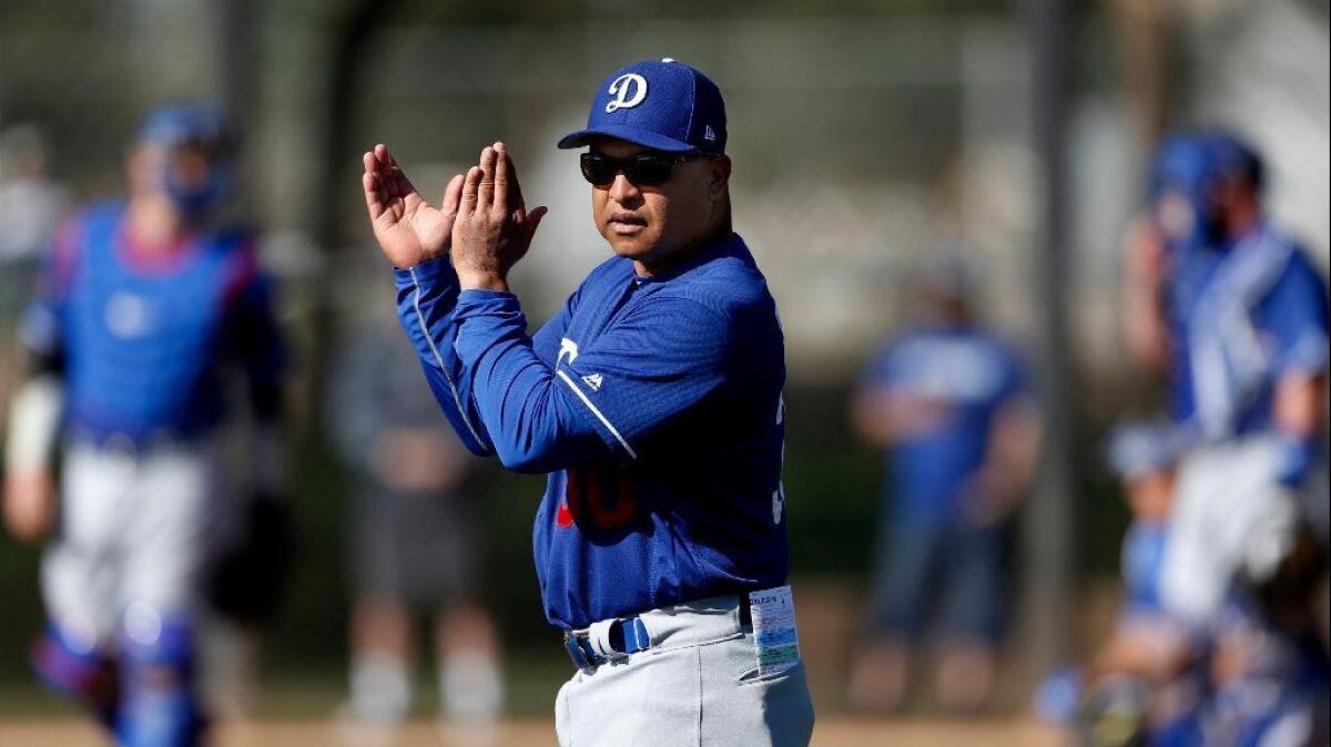 Dodgers Manager Dave Roberts offers encouragement during a spring training practice on Feb. 23.
