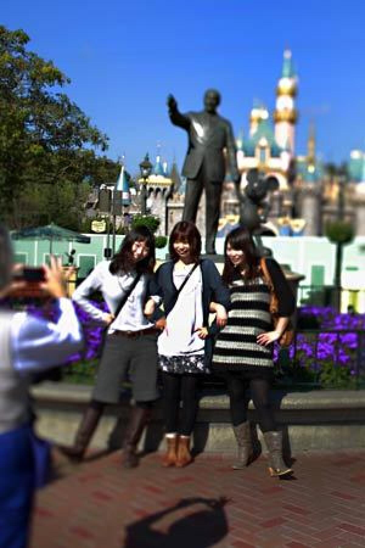 Japanese tourists take a photo at Disneyland. California was the third-most popular destination in the U.S. for international travelers last year