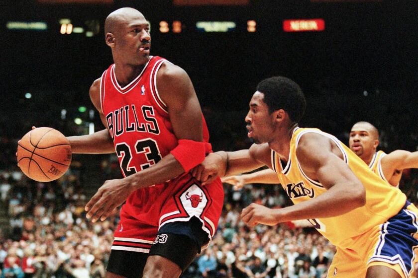 Michael Jordan of the Chicago Bulls (L) eyes the basket as he is guarded by Kobe Bryant of the Los Angeles Lakers during their 01 February game in Los Angeles, CA. Jordan will appear in his 12th NBA All-Star game 08 February while Bryant will make his first All-Star appearance. The Lakers won the game 112-87. AFP PHOTO/Vince BUCCI (Photo by VINCE BUCCI / AFP) (Photo credit should read VINCE BUCCI/AFP via Getty Images)
