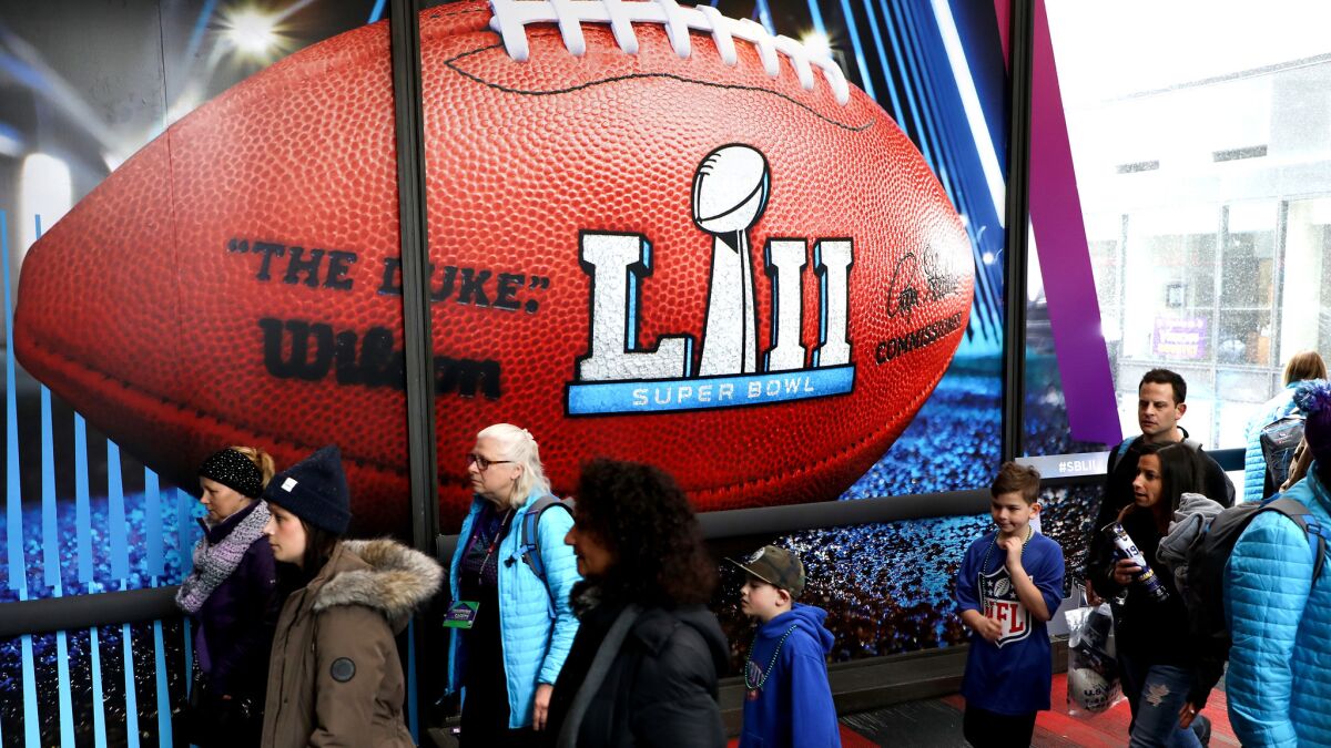 Fans make their way through Nicollet Mall during the Super Bowl live event on Saturday in Minneapolis.