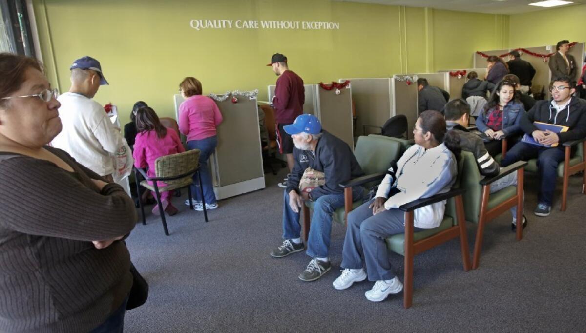 Los Angeles residents wait to sign up for health insurance starting Jan. 1 at an AltaMed enrollment center in late December.