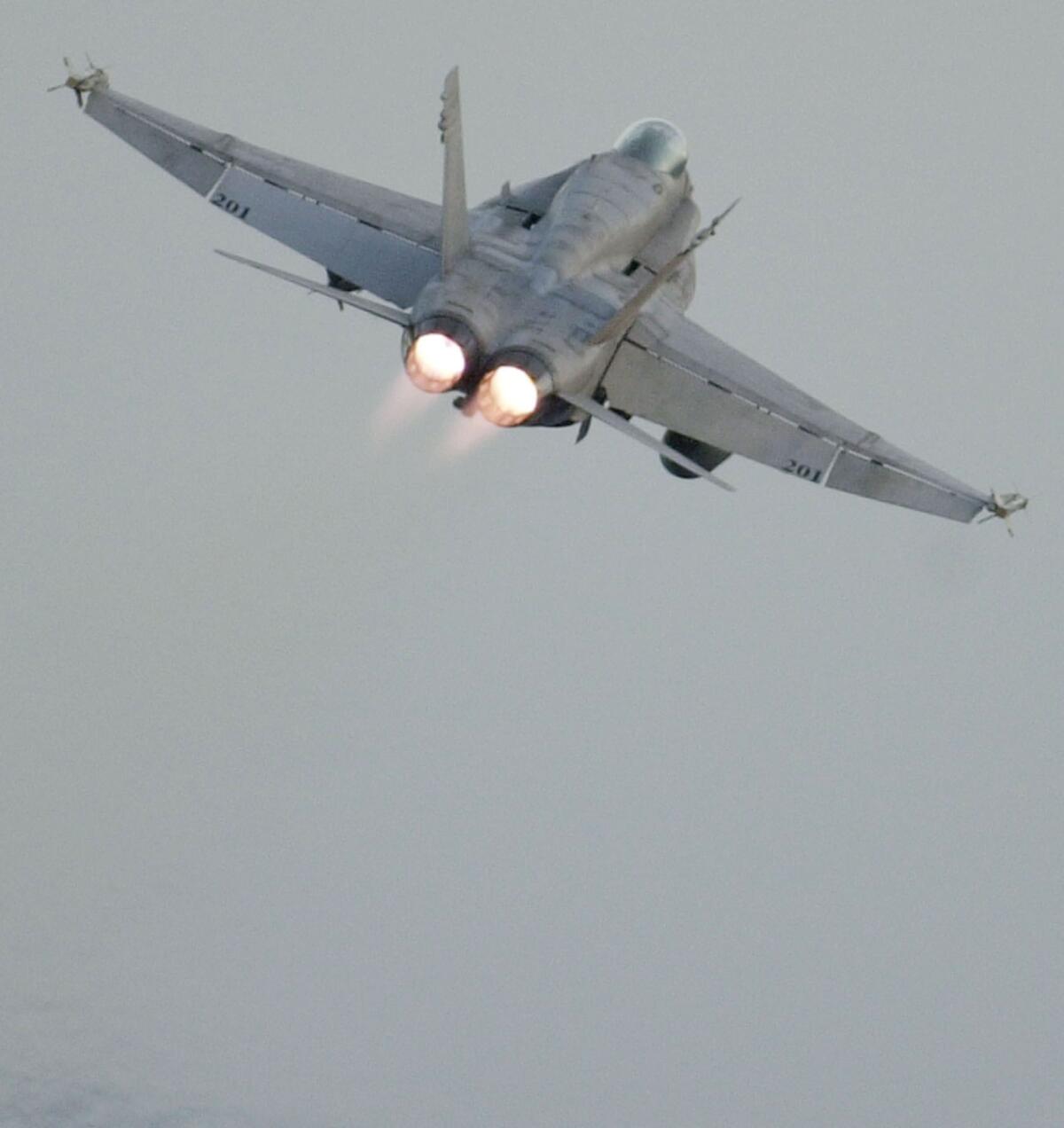 A Navy F/A-18C Hornet takes off on a strike mission from the aircraft carrier Theodore Roosevelt in the Arabian Sea in 2001. The pilot whom authorities are searching for in Nevada was flying a similar craft.