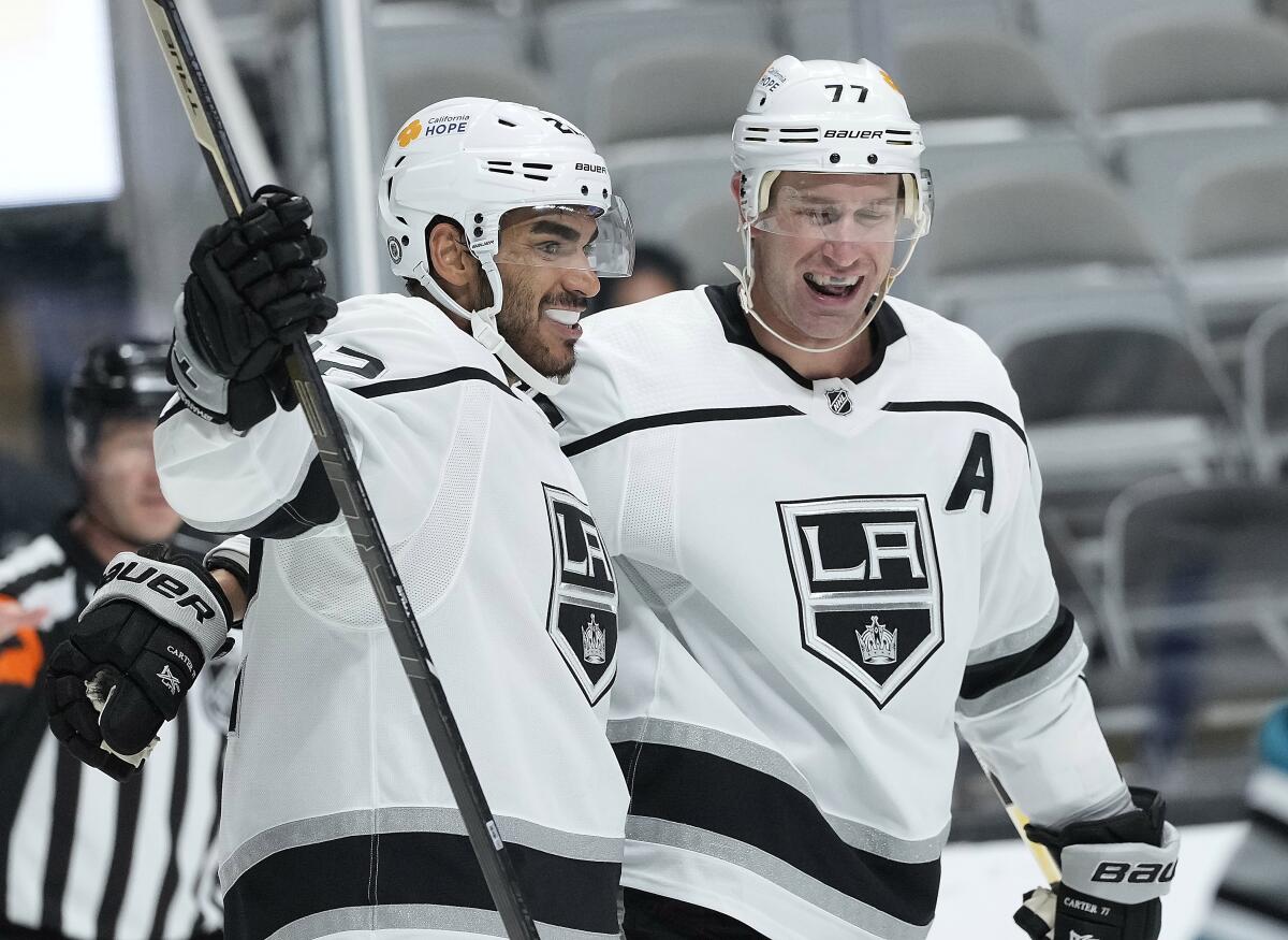 Kings forward Andreas Athanasiou celebrates with center Jeff Carter after scoring a goal.