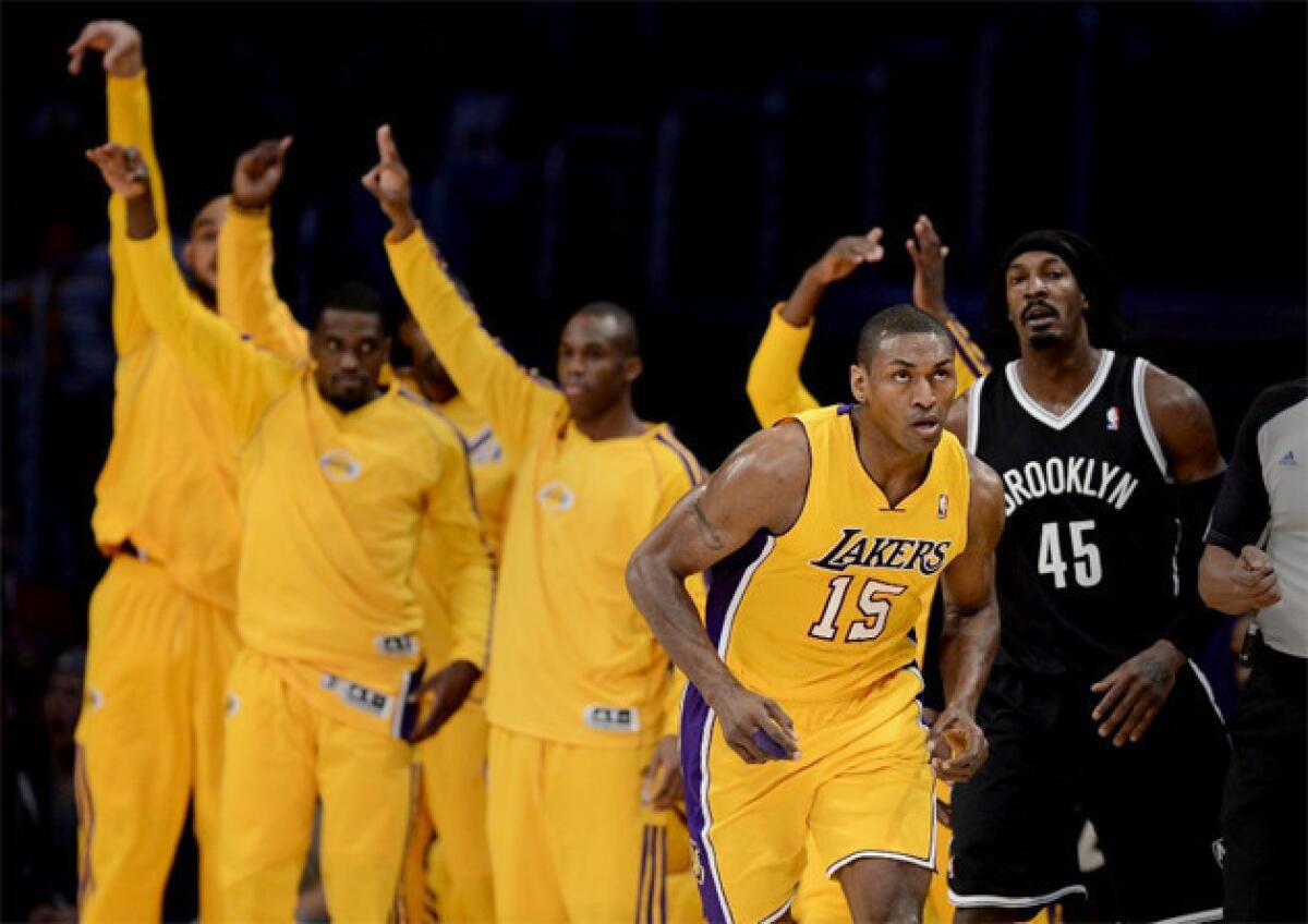 Lakers bench players celebrate a Metta World Peace three-pointer.