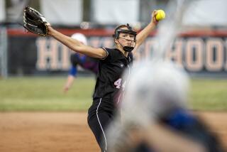 Huntington Beach's Zoe Prystajko pitches during a Surf League game against Los Alamitos at Huntington Beach High School on Tuesday, March 22.