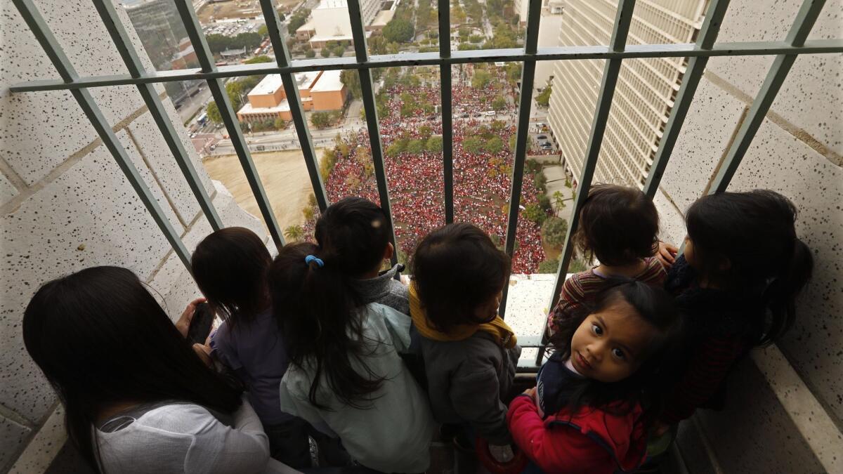 Children at the Joy Picus Child Development Center take in a bird's eye-view of the thousands of educators with United Teachers Los Angeles taking part in a rally in Grand Park.