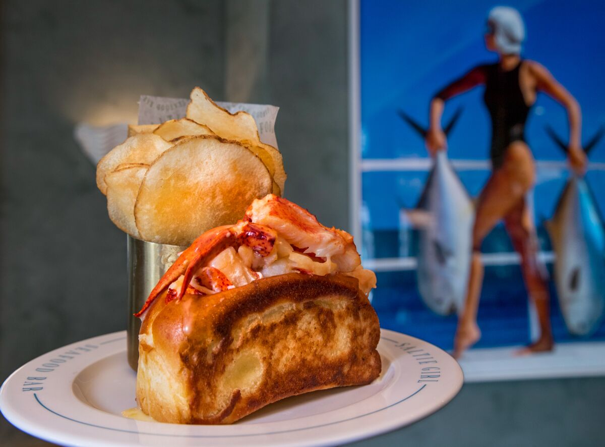 A warm lobster roll with house-made salt and vinegar chips