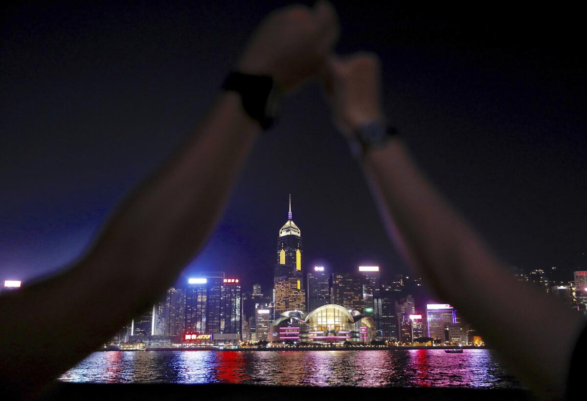 Demonstrators link hands as they gather at the Tsim Sha Tsui waterfront in Hong Kong, Friday, Aug. 23, 2019. Supporters of Hong Kong's pro-democracy movement are linking hands across the semi-autonomous Chinese territory, inspired by a historic protest 30 years ago in the Baltic states when nearly 2 million people formed a human chain to protest Soviet control. (AP Photo/Vincent Yu)