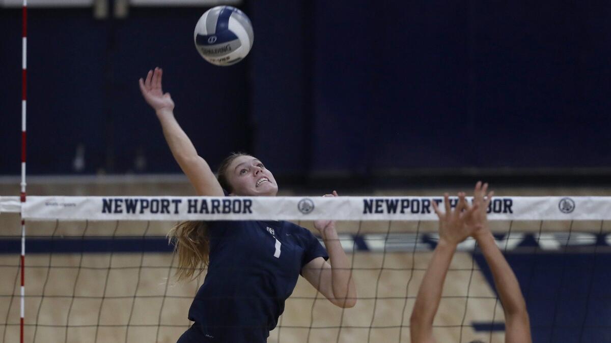 Newport Harbor High's Kendall Bagby spikes the ball against Laguna Beach during the second set of a Wave League match on Wednesday.