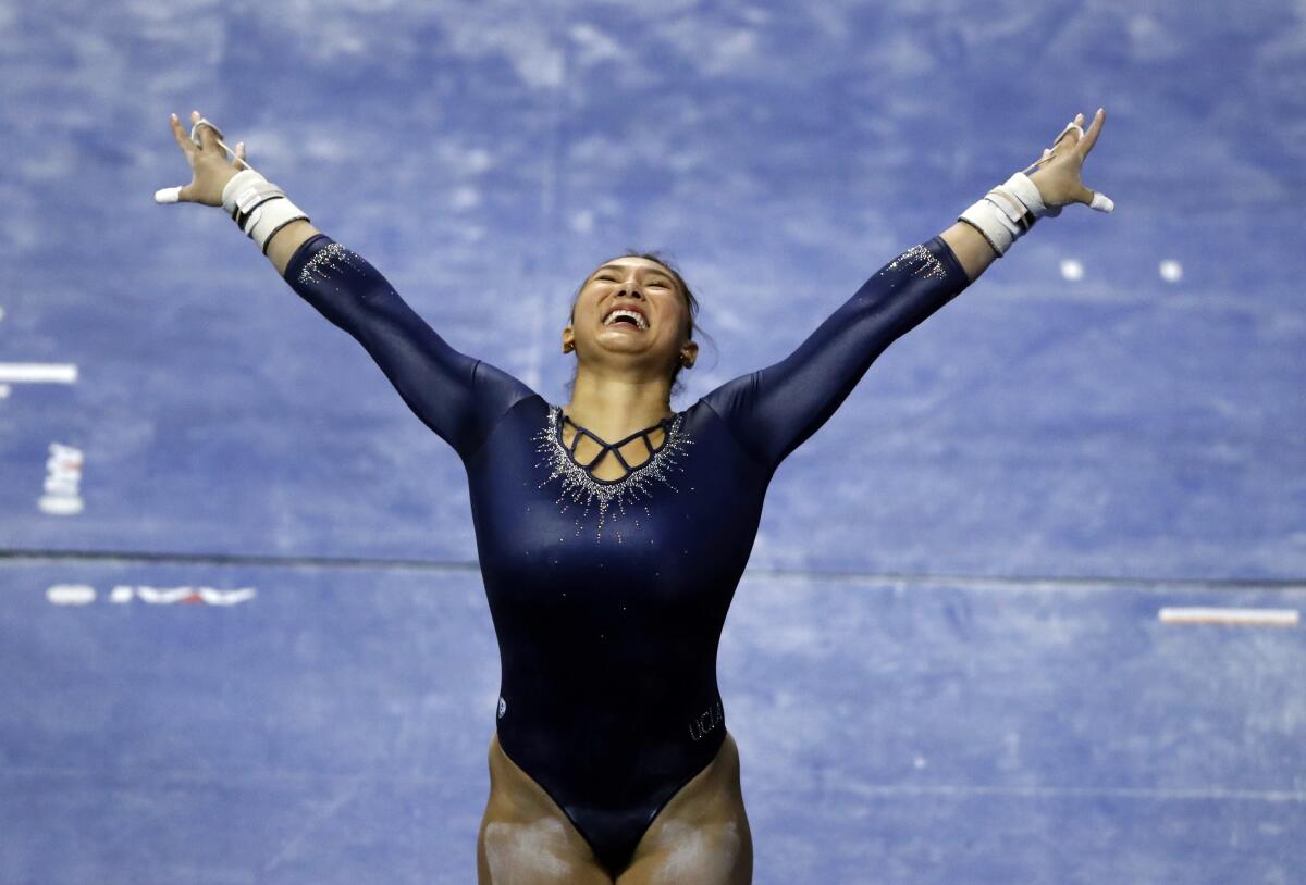 UCLA's Kyla Ross smiles after completing her uneven parallel bars routine during the NCAA championships April 20, 2018.