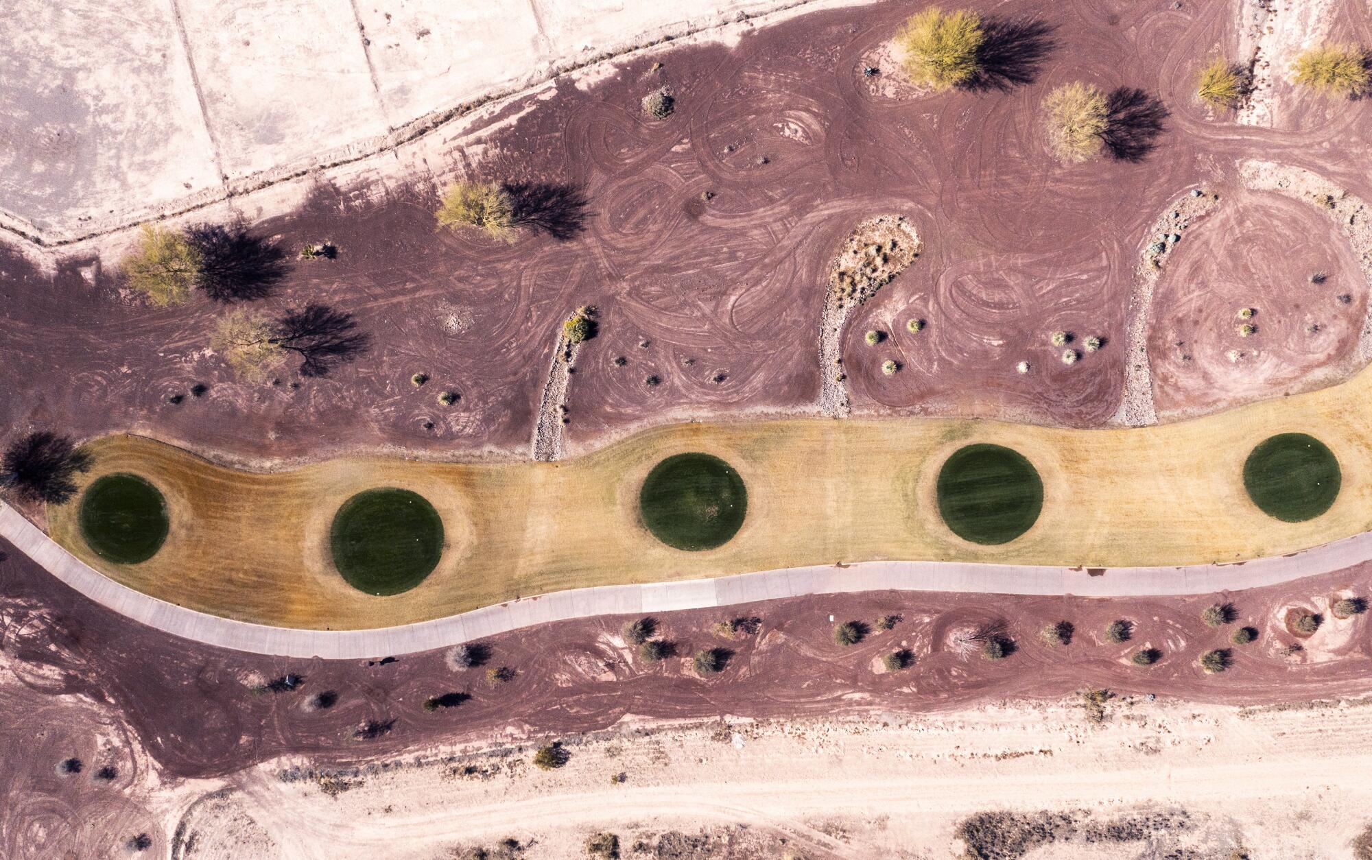 An aerial view of tee boxes on a golf course at an Anthem development in Florence, Ariz.