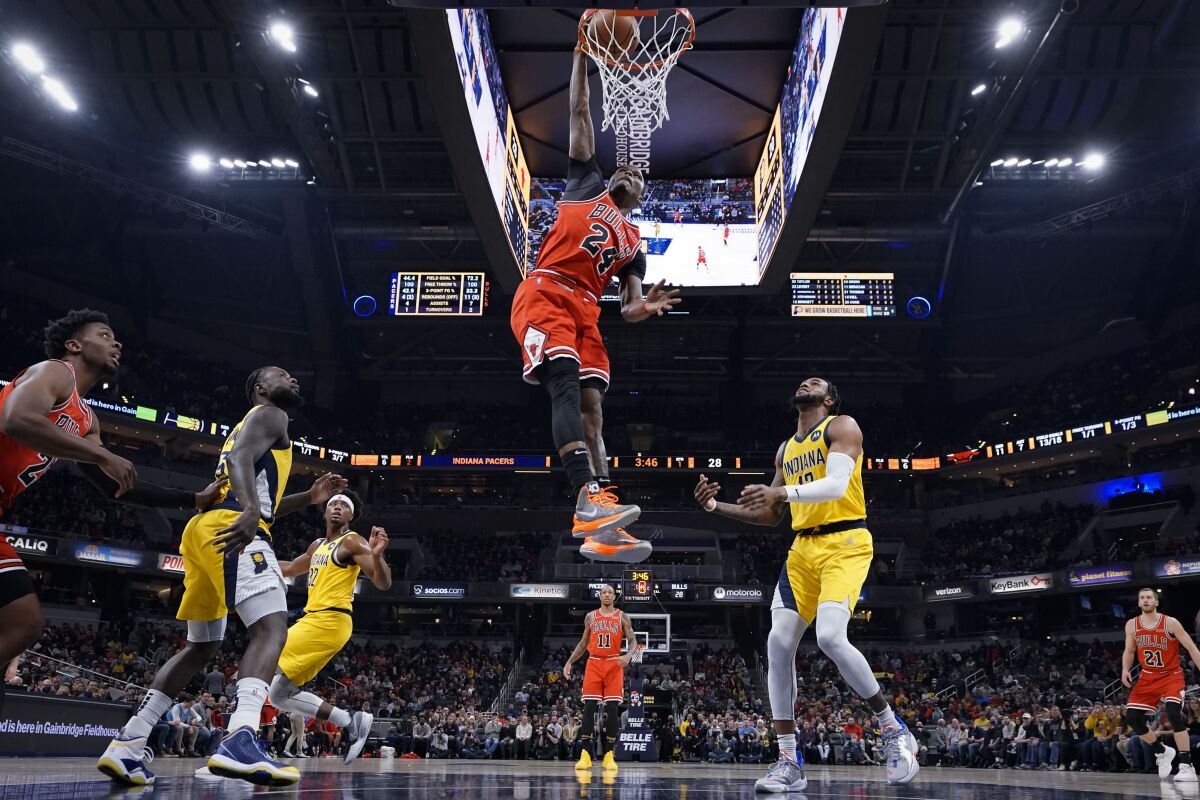 Chicago Bulls forward Javonte Green (24) dunks in front of Indiana Pacers forward Oshae Brissett (12) during the first half of an NBA basketball game in Indianapolis, Friday, Feb. 4, 2022. The Bulls won 122-115. (AP Photo/AJ Mast)