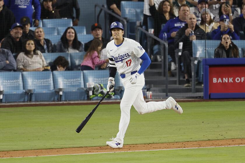 Dodgers designated hitter Shohei Ohtani watches the ball after hitting against the Giants Tuesday at Dodger Stadium.