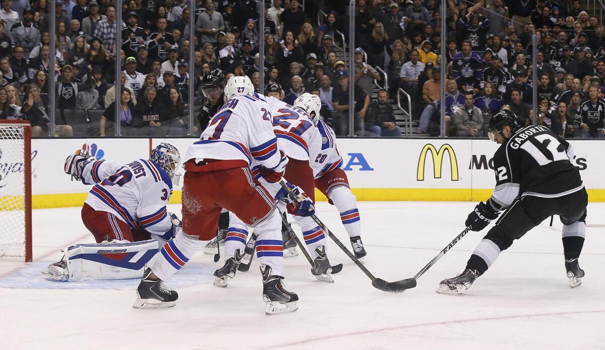 Kings right wing Marian Gaborik collects the puck in front of three Rangers and scores on goaltender Henrik Lundqvist to tie the score in the third period of Game 2.