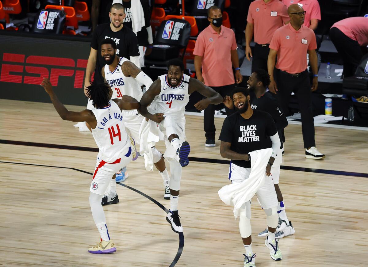 Clippers players celebrate after breaking a team three-point record against the Pelicans on Aug. 1, 2020.